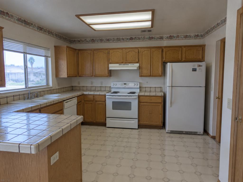 1990s builder kitchen reworked around a white oak island in Summerlin, Las Vegas — before kitchen remodeling photo